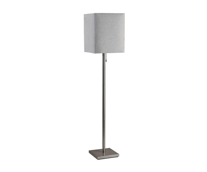 The Fiora Floor Lamp is a modern floor lamp featuring a rectangular gray fabric shade, a slim brushed steel metal pole, and a square metal base, standing upright against a white background.
