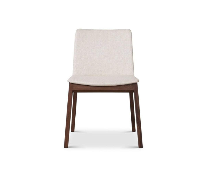 The Fuchsia Dining Chair in FUCHSIA BEIGE is displayed from the front, featuring a beige upholstered seat and backrest with four straight wooden legs, set against a white background.