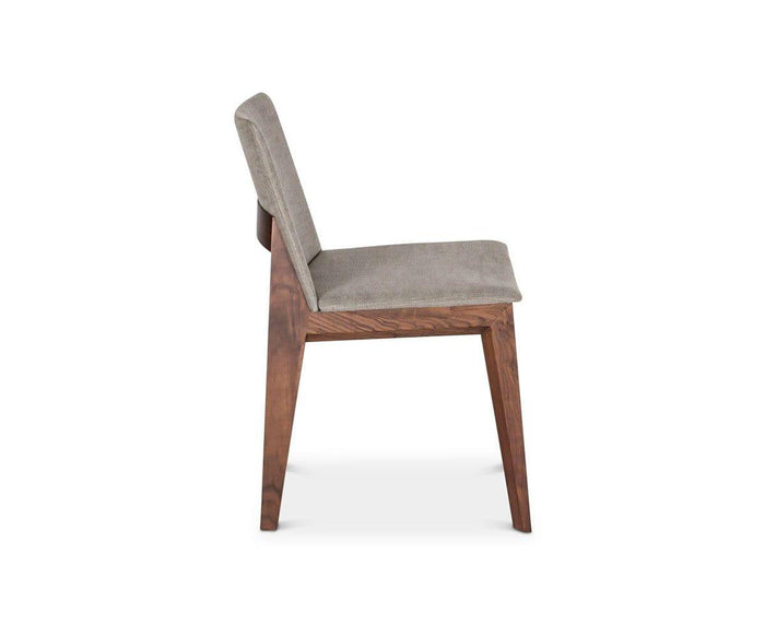 Side view of the Fuchsia Dining Chair—a modern piece with a cushioned gray seat and backrest, supported by a wooden frame with angled legs—shown against a plain white background.