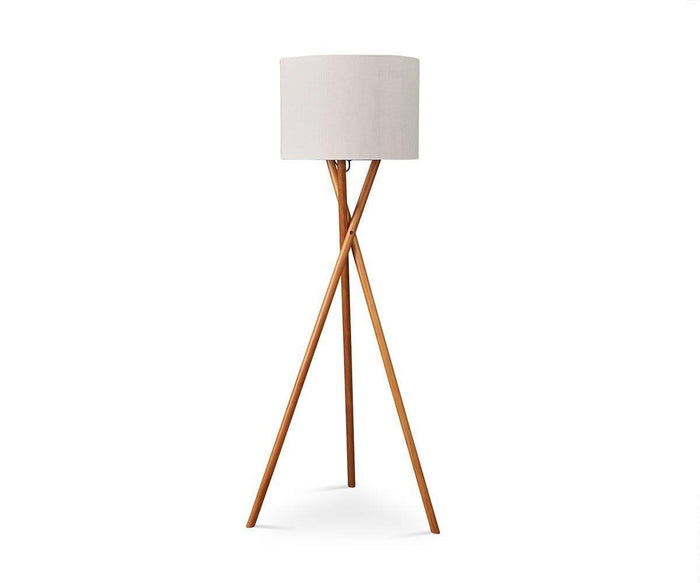 The Gaffel Floor Lamp, in a sophisticated Acacia finish, features three wooden legs forming a stylish tripod base and a white cylindrical lampshade. Set against a plain white background, this modern lamp combines contemporary design with practicality, making it an ideal addition to your home decor.