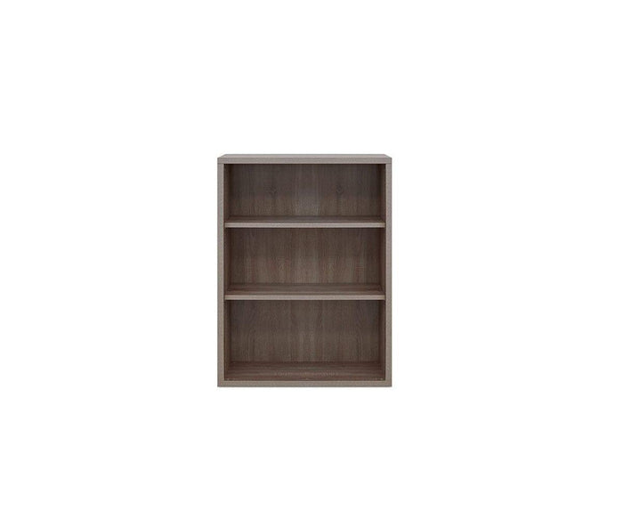 The Gammel Low Bookcase, featuring three shelves and a TRUFFLE OAK finish, is crafted from recycled materials and stands empty against a plain white background.
