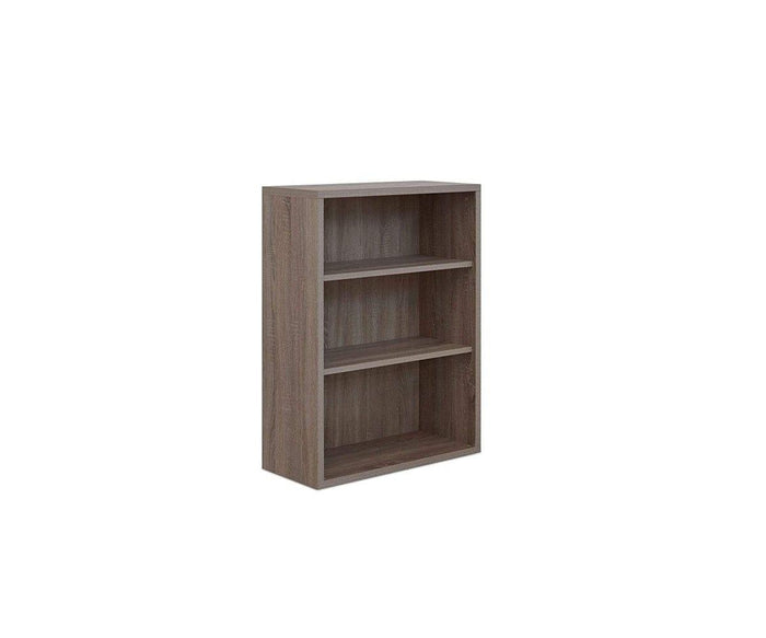 The Gammel Low Bookcase, a small three-shelf unit crafted from recycled wood and finished in light brown, stands against a plain white background. This eco-friendly piece is ideal for bringing sustainable style to any modern workspace storage.