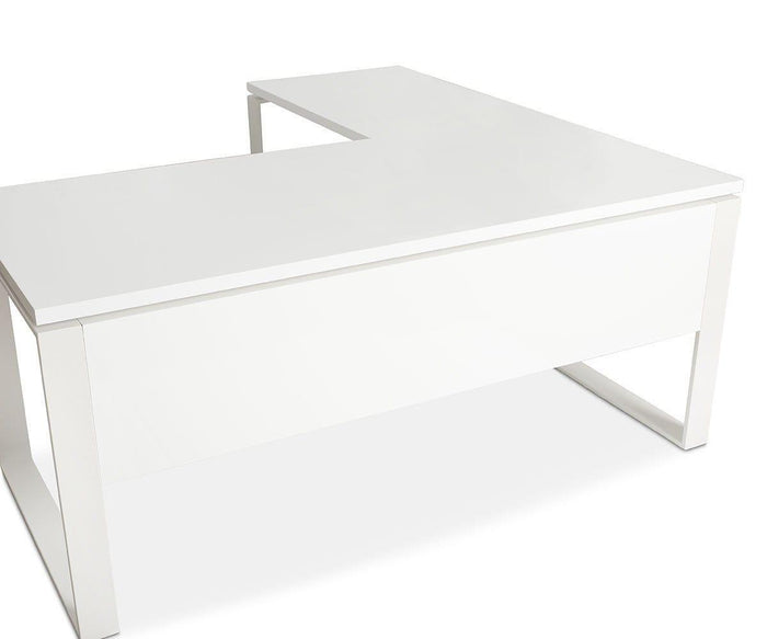 The Gammel Return Desk - White is a modern L-shaped desk with clean lines, featuring a smooth surface and minimalist metal legs. An eco-friendly extension provides added workspace, all set against a plain white background.