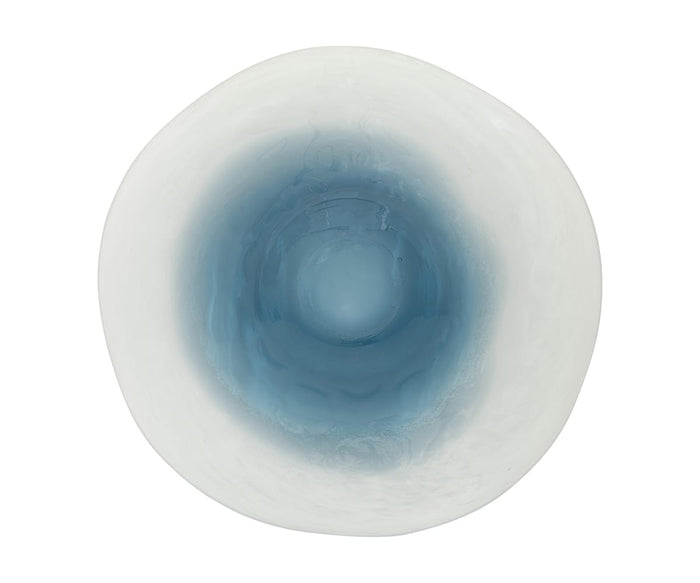 Viewed from above, the Glacier Bowl features a round, white form with a smoothly uneven rim. Its interior transitions from crisp white at the edge to a rich, translucent blue at the center, capturing arctic-inspired hues that define its distinctive charm.