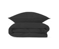 A neatly folded E03 Graphite comforter made from organic cotton bed linen, with a matching Graphite Sham propped up behind it, set against a plain white background.