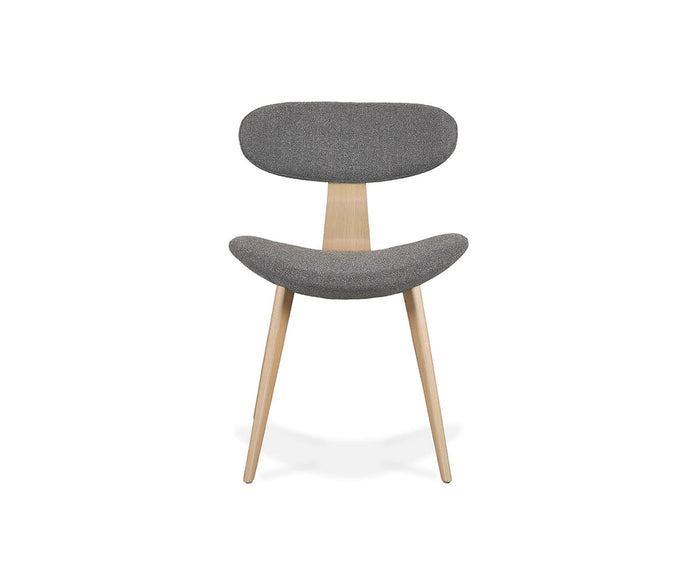 The Hana Dining Chair features solid white oak legs and a curved seat and backrest upholstered in gray performance fabric, displayed against a plain white background.