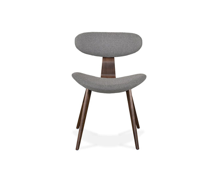 The Hana Dining Chair features a modern Scandinavian design with a curved, gray upholstered backrest and seat crafted from durable performance fabric. Supported by four angled solid white oak legs and a wooden central support, this minimalist and stylish chair is showcased against a plain white background.