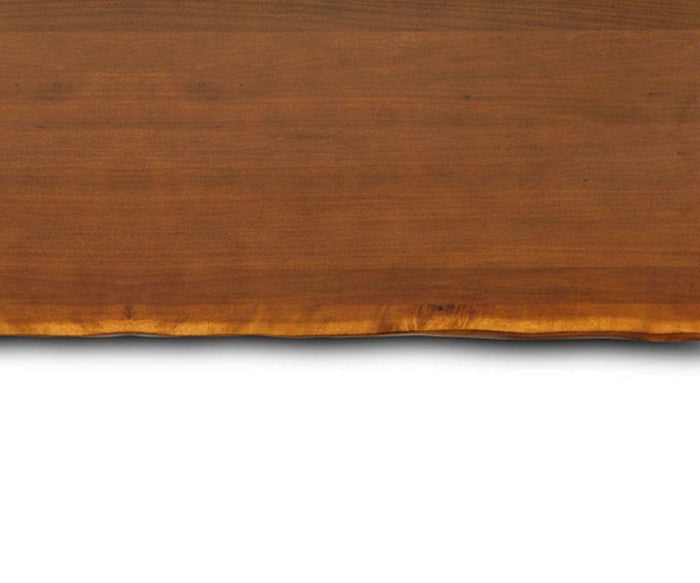 A close-up of the Hasse 35″ Shelf highlights its wooden surface, featuring a natural, uneven bottom edge. The prominent wood grain and rich brown hues showcase the character of this rustic shelf against a white backdrop.