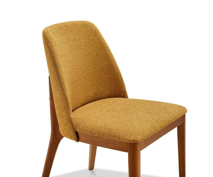 The Hendrick Dining Chair is a modern wooden dining chair with a durable frame, featuring a mustard yellow cushioned seat and backrest, angled legs, and a slightly reclined back.