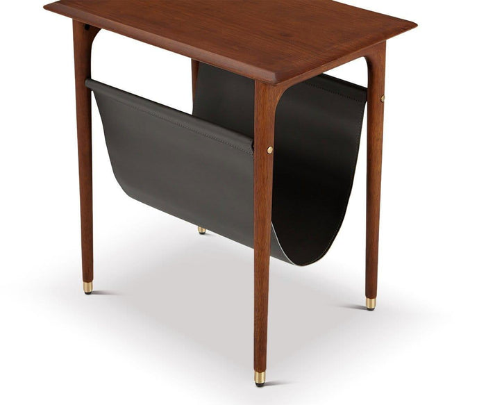 Introducing the Hendrick End Table with Hanging Shelf—a mid-century style end table expertly crafted from American poplar wood. This wooden side table stands on four legs accented with elegant brass leg caps, and features a built-in black leather sling beneath the tabletop, perfect for storing magazines or newspapers.