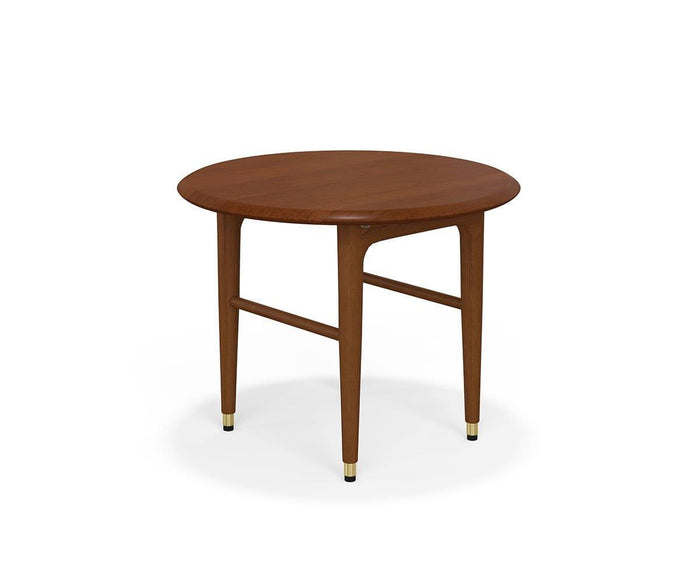 The Hendrick Round End Table is crafted from American poplar wood and features four tapered legs, each finished with a small brass cap. Showcasing a simple mid-century modern design, the table is displayed against a plain white background.