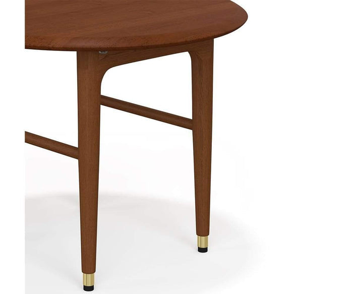 Here’s your rewritten sentence using the product data: A close-up of the Hendrick Round End Table highlights its round American poplar wood tabletop and clean mid-century modern design. The wooden leg features elegant brass caps at the base, all presented against a white background for a sophisticated look.