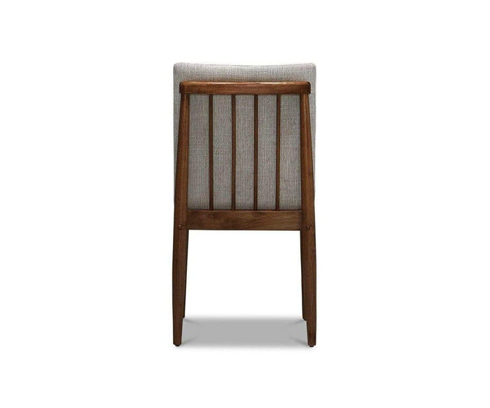 The Holfred Dining Chair features a Scandi-inspired design with a light gray upholstered backrest, seen from behind. Three vertical wooden slats connect the two rear legs, and the chair is photographed against a plain white background.