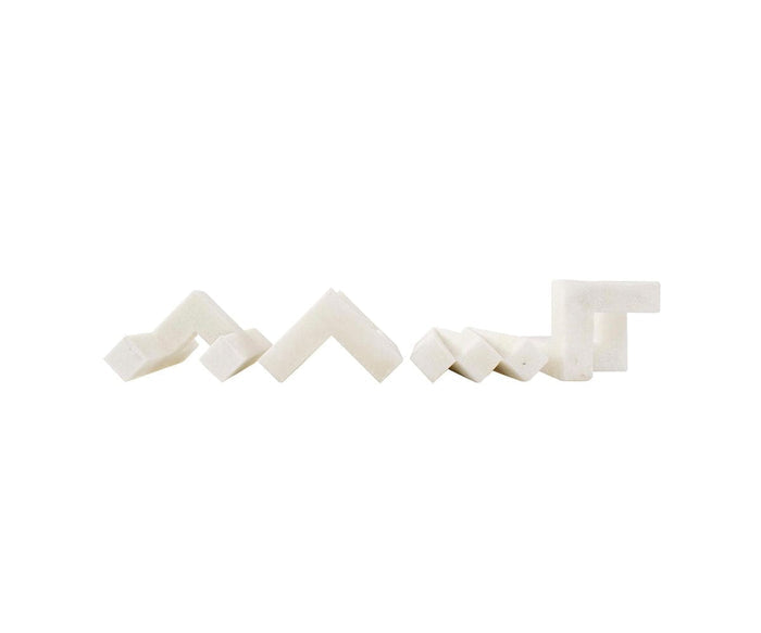 Four Home Sculpture pieces in white, featuring angular, zigzag, and stepped geometric shapes, are arranged in a row on a plain white background, providing a contemporary design ideal for modern decor.