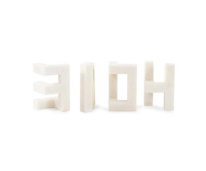 Four white, blocky Home Sculptures, each resembling abstract or stylized letters, are lined up in a row against a plain white background, creating a contemporary shape perfect for modern decor.