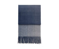 Introducing the Horizon Throw, an eco-friendly accent crafted from recycled alpaca wool. This folded throw features a checkered pattern in dark blue on the upper section and light gray on the lower section, complete with fringed ends for added texture.