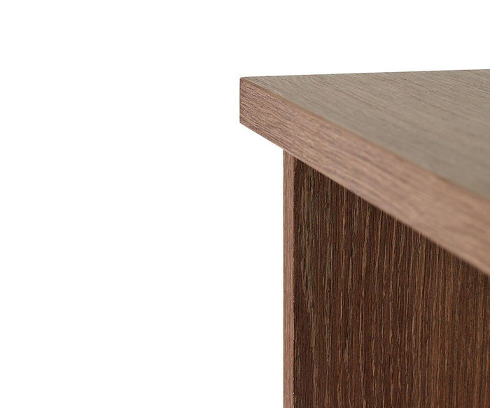 Close-up of the top corner of the Inari Low Bookcase, featuring a smooth, dark brown finish and visible wood grain texture—perfect for office storage with adjustable shelves.
