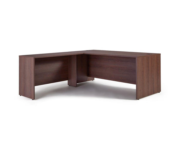 The Inari Reversible Return is a wooden L-shaped desk with a dark brown finish, featuring clean lines and a minimalist design. Ideal for any office workspace, the desk includes solid panels on the sides and back, an open area underneath for legroom and storage, and a reversible return to accommodate your layout preferences.