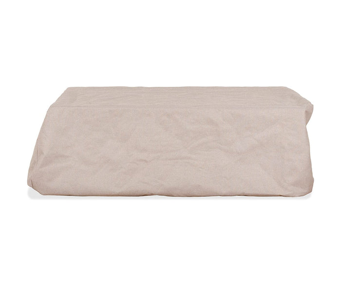 The Iona Coffee Table Cover in A02 Cream, a rectangular all-season outdoor furniture cover, rests on a white background. Its fabric displays gentle wrinkles, lending a soft, textured appearance and highlighting its water-resistant qualities for year-round protection.