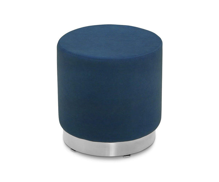 The Isla Ottoman is a round piece upholstered in plush blue velvet, showcasing a smooth fabric surface and an eye-catching brass base, presented on a plain white background.