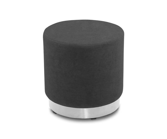 The Isla Ottoman features a round silhouette upholstered in black velvet and is accented with a sleek brass base, showcased against a white background.