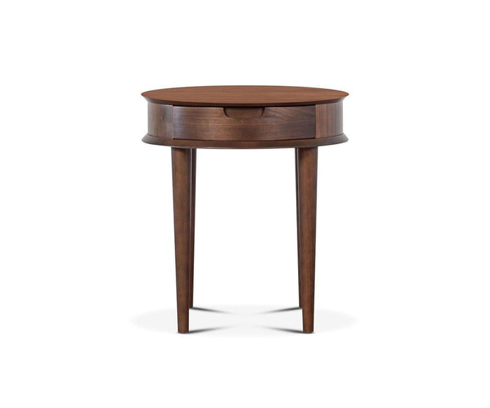 The Juneau End Table in walnut showcases a round, wooden mid-century design with three tapered legs and a small drawer, photographed against a plain white background.