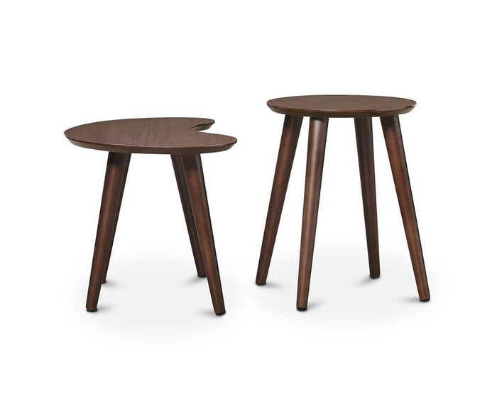 Introducing the Juneau Nest Of Tables: this stylish set includes two wooden side tables with rich dark brown finishes, exemplifying mid-century modern design. One table features a classic circular top, while the other is highlighted by its unique kidney-shaped surface. Each piece stands on three angled legs, making them ideal accent pieces for any living space and displayed elegantly against a plain white background.