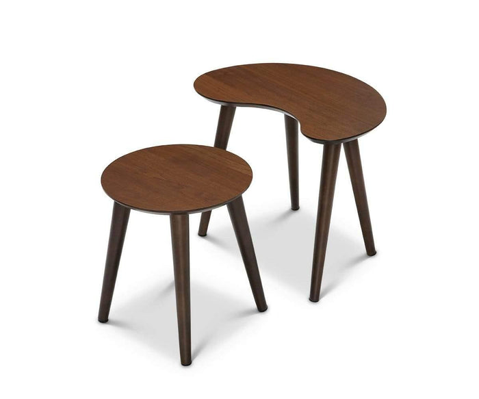 The Juneau Nest Of Tables brings mid-century modern flair to your living space with two wooden side tables in a dark brown finish—one featuring a round top and the other showcasing a unique kidney-shaped surface. Each table stands on three angled legs and is arranged closely together against a crisp white background.