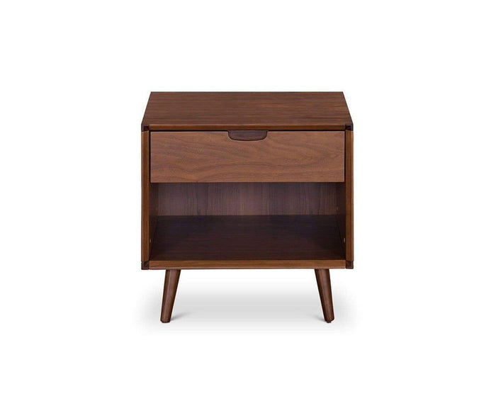 The Juneau Nightstand is a stylish mid-century piece crafted from wood, featuring angled legs, a single drawer with a cutout handle, and an open storage shelf below. Its smooth WALNUT finish brings sophisticated charm to your bedroom furniture.