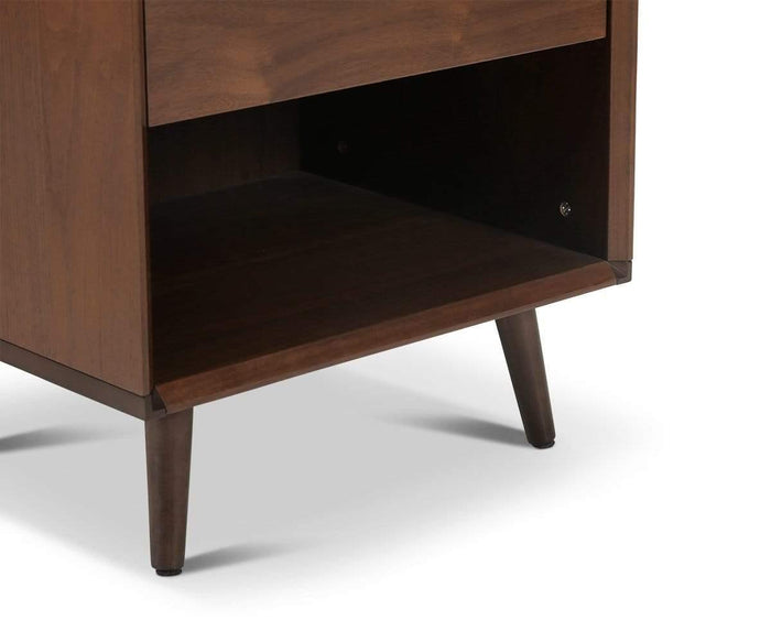 Close-up of the bottom portion of the Juneau Nightstand, featuring tapered legs and an open lower shelf, set against a white background.