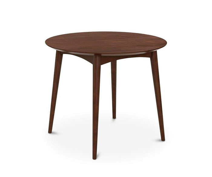 The Juneau Round Table exemplifies Scandinavian design with its dark wood construction and four elegant tapered legs, presented against a white background.