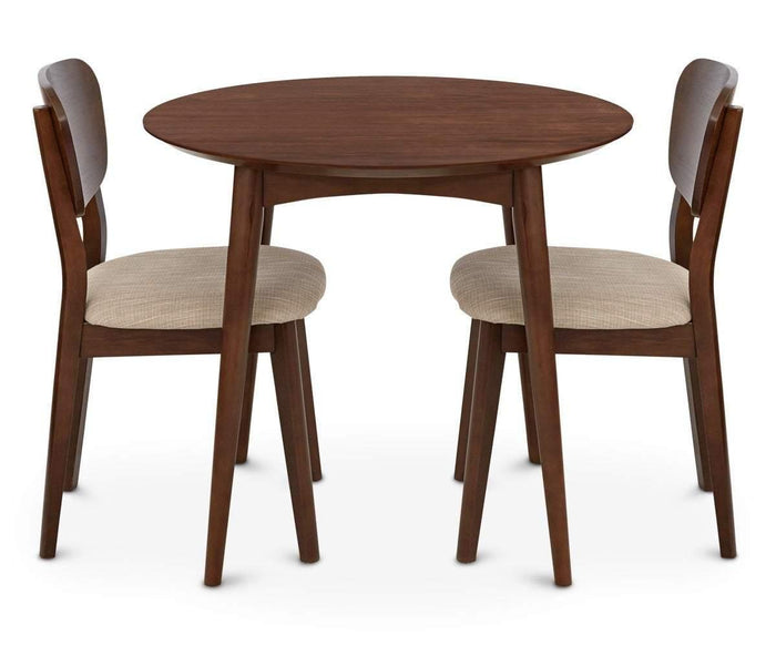 The Juneau Round Table, featuring a small round tabletop with tapered legs, is paired with two cushioned chairs facing each other on a white background, highlighting its subtle Scandinavian design influences.