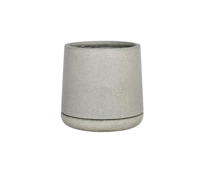 A simple, light grey, cylindrical Kamden Planter featuring a slightly wider bottom edge is shown against a white background. This lightweight fiberstone planter offers a blend of modern simplicity and durability.