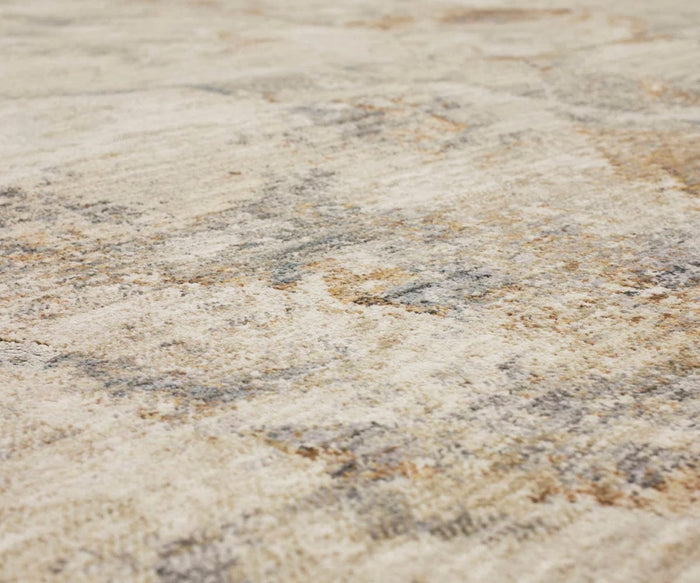 Close-up of a textured surface with a blend of beige, gray, and brown tones, reminiscent of the abstract motif found in the Karastan Echo Tesoro Rug - Cream or a durable area rug with a softly patterned appearance.