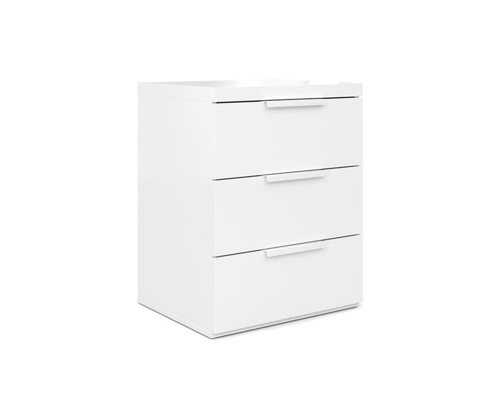 The Knox Nightstand is a white, three-drawer dresser featuring sleek, modern handles and a high-gloss finish, displayed against a plain white background. This eco-friendly piece easily complements any space as a contemporary nightstand or storage solution.