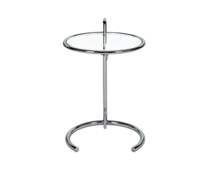 The Krom C-Table is a modern round side table with a chrome frame, clear glass top, and an eye-catching circular base. It showcases a minimalist design with a vertical central support, adjustable height functionality, and a convenient small handle at the top for easy mobility.
