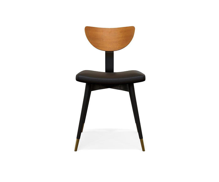 Introducing the Lanson Dining Chair in a light walnut stain and black finish, showcasing a modern mid-century design with a curved bentwood backrest, cushioned seat upholstered in black faux leather, and sleek black legs accented by gold-colored tips on the front legs, displayed against a white background.
