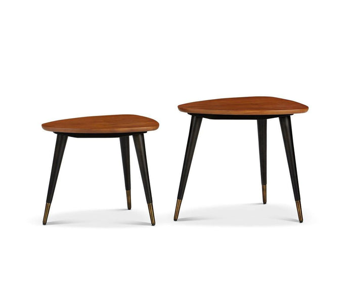 The Lanson Nest Of Tables features two mid-century modern nesting tables with light walnut stain American poplar wood tops and three tapered black legs per table, each accented with gold-colored tips, displayed on a white background.