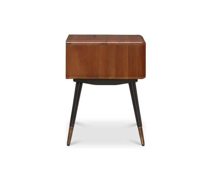 The Lanson Nightstand features a mid-century modern design with a rectangular walnut wooden top, tapered black legs, and brass-capped feet, displayed against a white background.