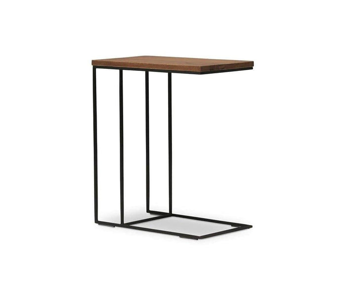 The Leende C-Table features a modern, rustic-industrial design with a thin black metal frame and a rectangular European oak top, expertly crafted to slide under sofas or chairs for space-saving convenience.