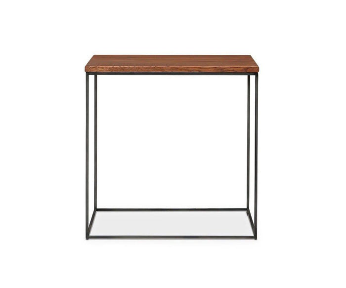 The Leende End Table features a rectangular European oak top in an oiled honey finish and a slender blackened steel frame, shown against a white background—an ideal piece of industrial accent furniture for modern interiors.