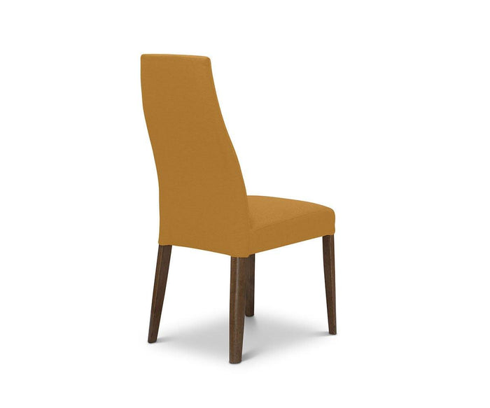 A contemporary Lussa Fabric Dining Chair with a tall backrest and seat upholstered in mustard-yellow fabric, set on four dark-finished solid wood legs and presented at an angle.