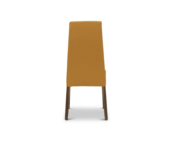 A Lussa Fabric Dining Chair in mustard yellow, featuring fabric upholstery and dark solid wood legs, is shown from the back against a white background.