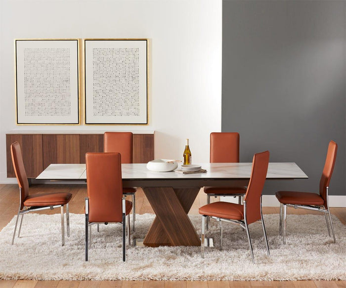Modern dining room featuring a marble table, six Lykke High Back Dining Chairs that offer padded comfort, a white rug, wooden sideboard, and two abstract framed artworks on the wall. A bottle and dishes are on the table.