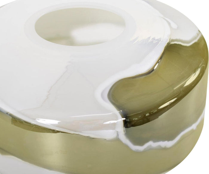 Close-up of the Malin Vase, a glossy, round vessel with a central opening, showcasing an abstract design that blends translucent beige and opaque white tones with smooth, flowing edges in neutral shades.