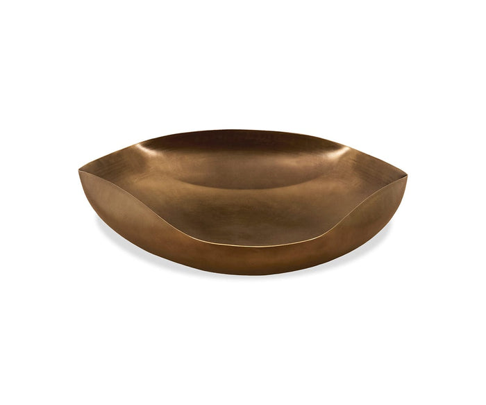 The Mara Dish, featuring a shallow, wide form with gently curved edges and a smooth aged bronze finish, adds an elegant decorative touch when displayed against a plain white background.