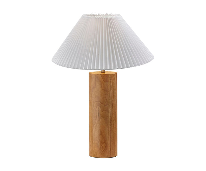 The Marta Table Lamp, in a natural finish, showcases a cylindrical wood base topped with a white pleated lampshade. Photographed against a plain white background, this modern lamp adds elegance and warmth to any space.