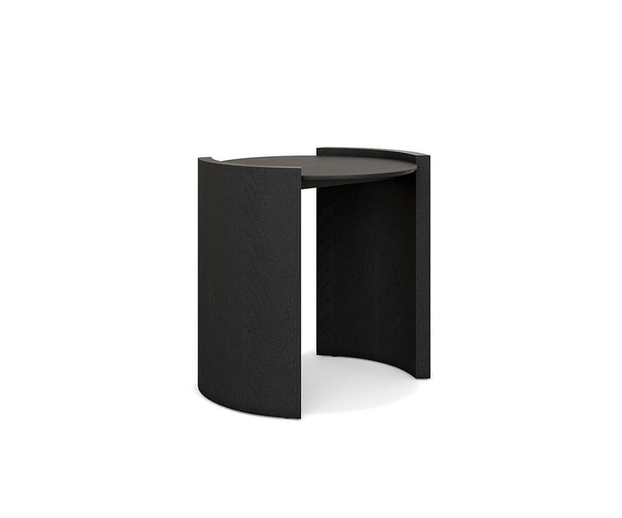 The Matteo Round End Table features a modern, minimalist design with a black, round ceramic tabletop and two outward-facing half-cylinder legs for a distinctive geometric look.