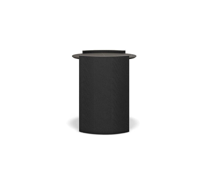 The Matteo Round End Table is a modern, cylindrical black side table with a flat, round top and a subtle wood grain texture, displayed against a plain white background.