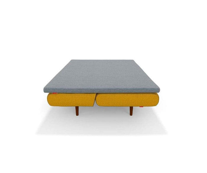 Modern low-profile bed with a gray mattress and yellow upholstered base, supported by four wooden legs, photographed against a plain white background—perfect for pairing with your favorite bedding or the Mattress Topper.
